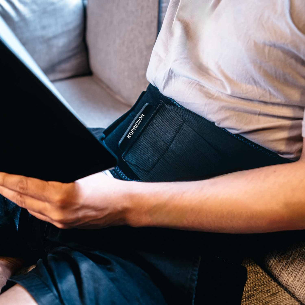 Koprezion Back CryoPump worn while reading on a sofa