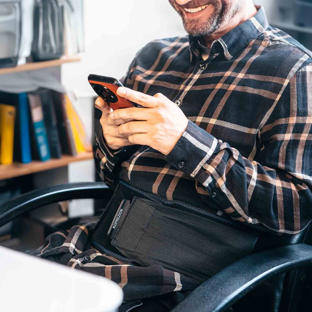 Man wearing the Koprezion Back CryoPump while seated